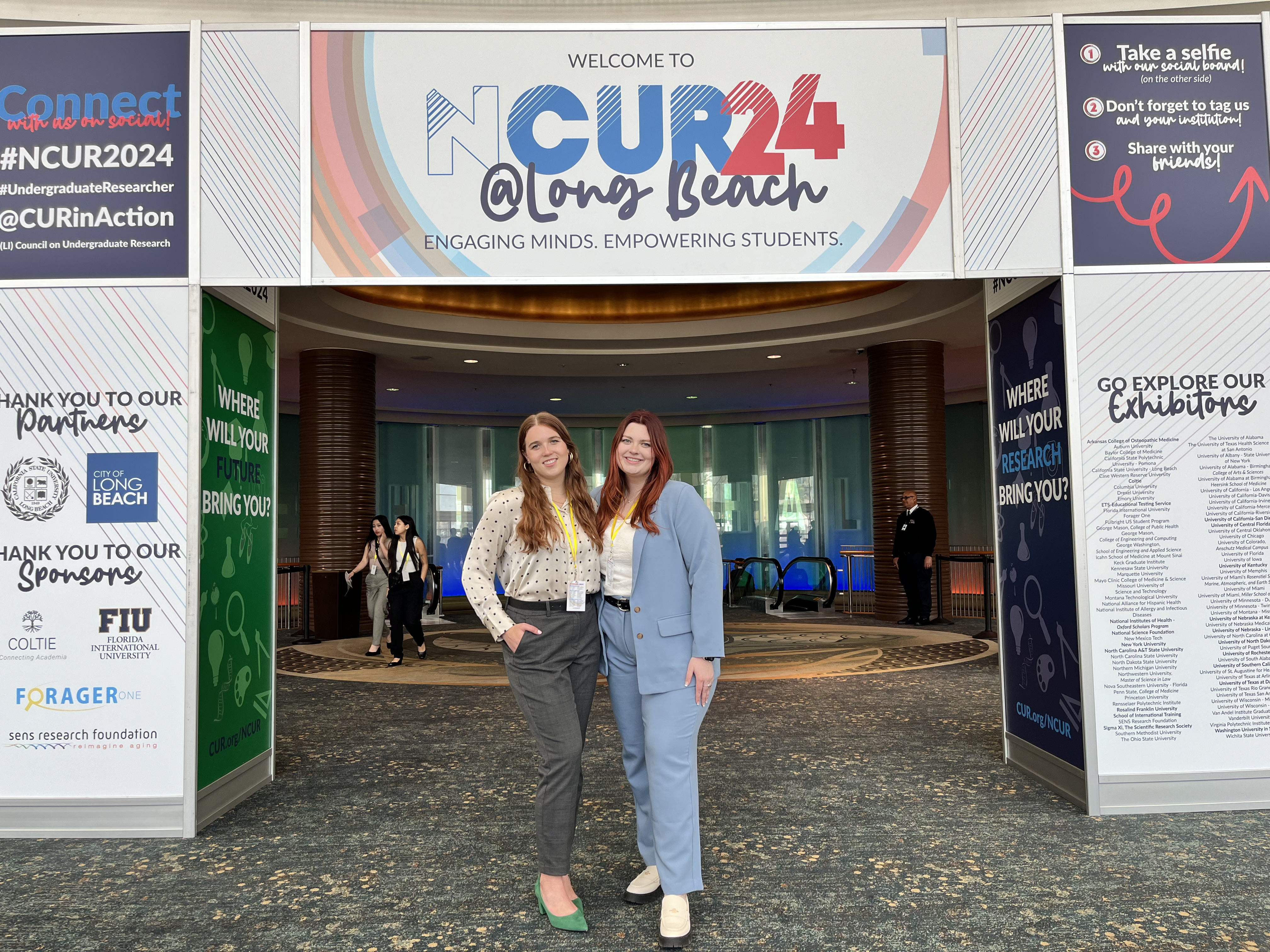 Two women standing in a convention hall