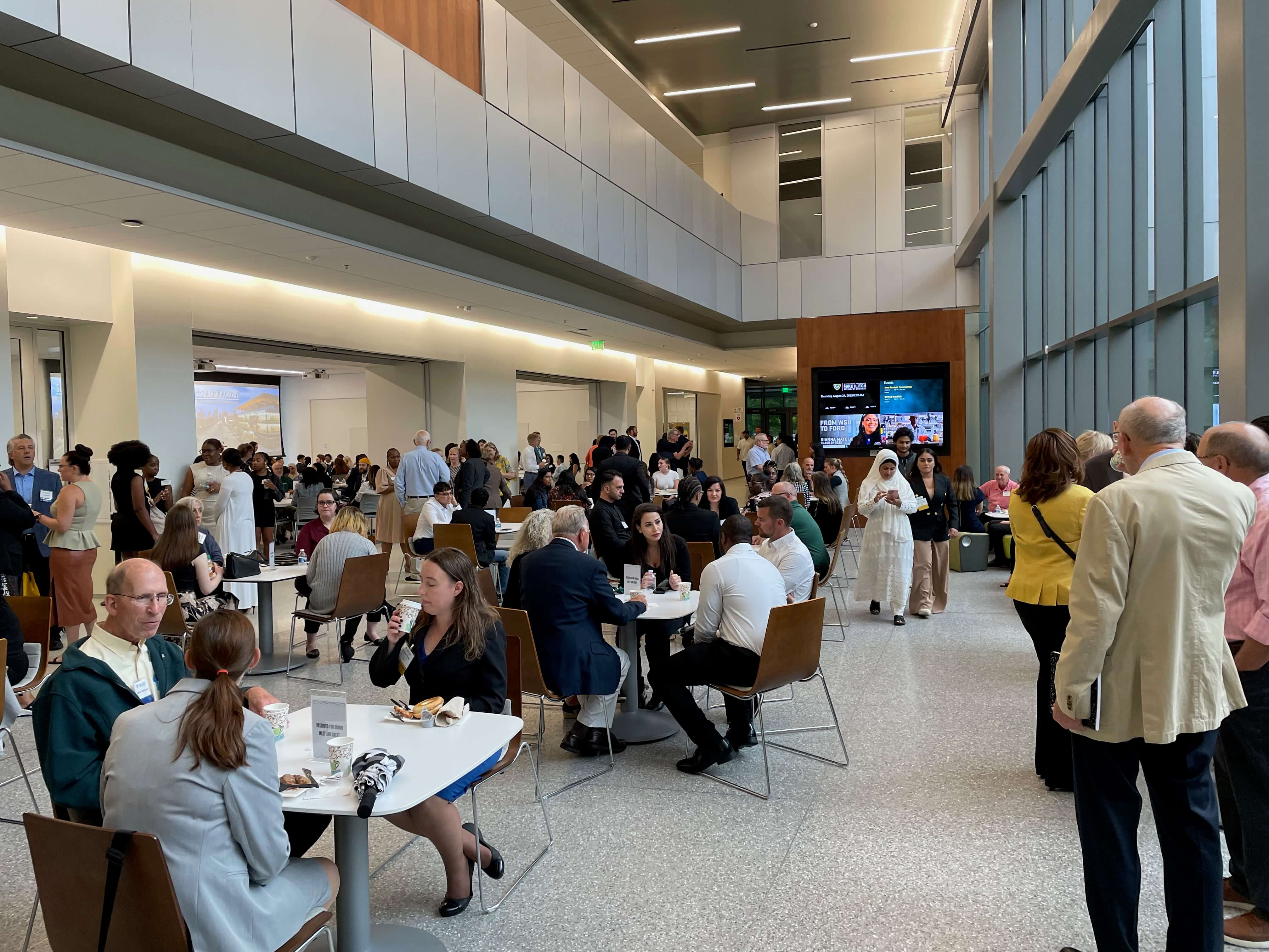 Ilitch School students and their families and faculty and staff enjoy refreshments in the atrium before the WSU scholarship event