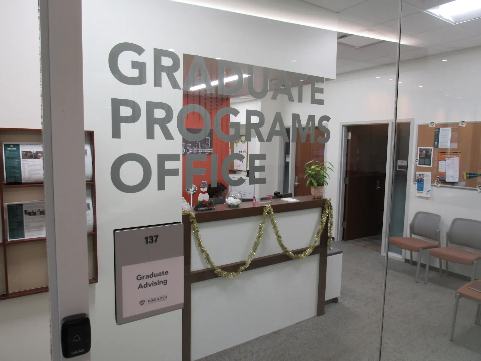 View of a glass window with the words &quot;Graduate Programs Office&quot; written on it