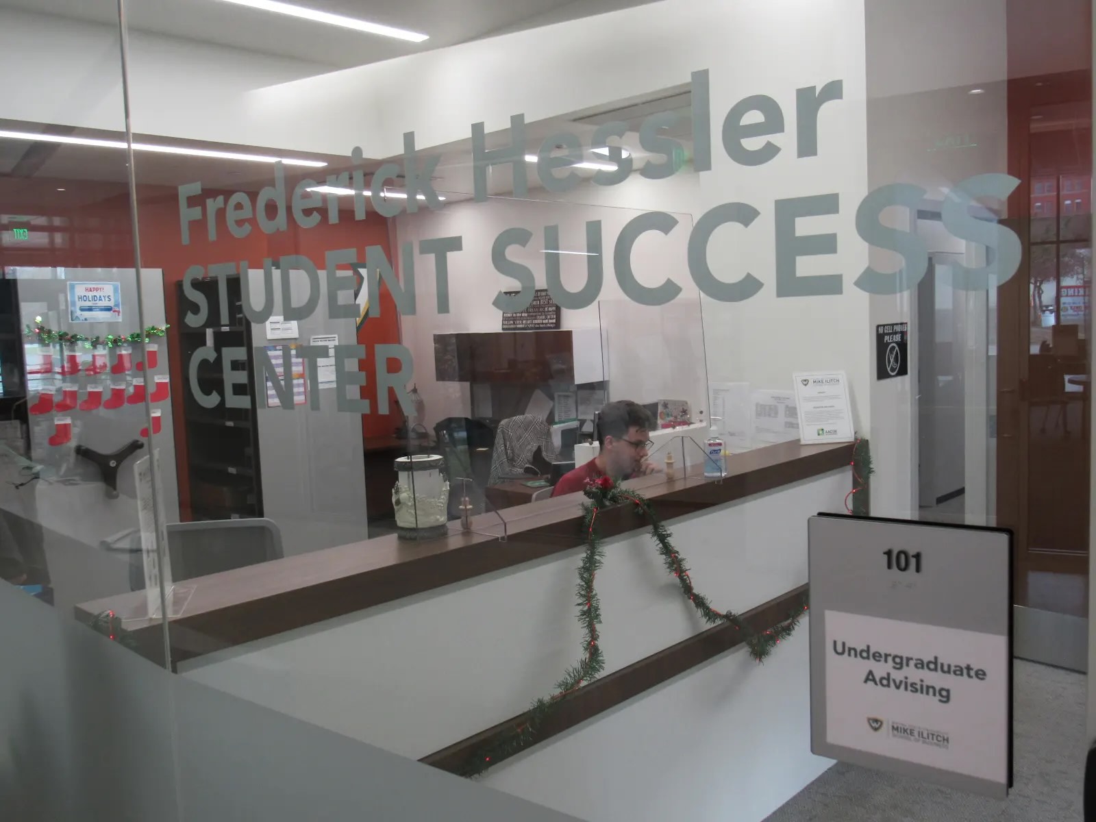 View of a glass window with the words &quot;Hessler Student Success Center&quot; written on it