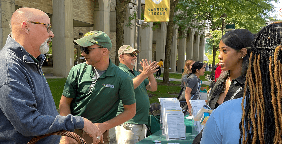 Ilitch School staff members talk to students at the graduate programs table during Fall Fest